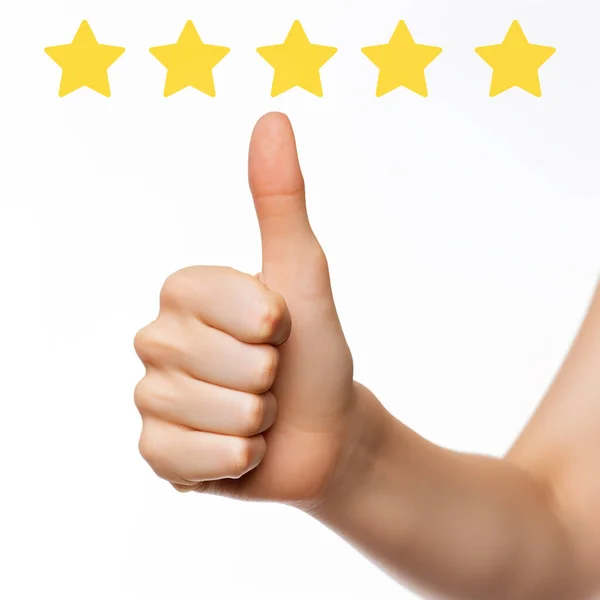 Closeup of male hand showing thumbs up with a five star rating.
