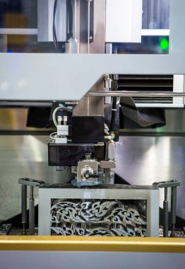 Electrical discharge machine EDM cutting metal workpiece in workshop. Industrial metalworking machinery.	