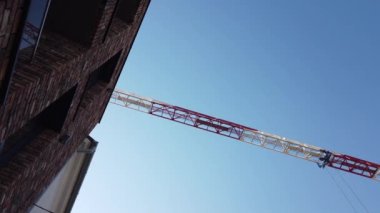 Moving tower crane against blue sky