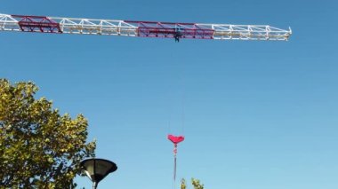 Moving tower crane against blue sky