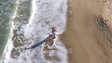 Güzel plaj elbisesi içinde, kumlu sahillerde yürüyen romantik, romantik bir kadın. 