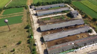  Flying over a bio farm, countryside cowshed, hangars, dairy cows, bio agricultural fields aerial 