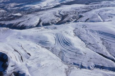 Aerial drone view of snow covered countryside terraces in the mountains clipart