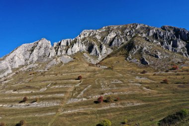 Aerial view of Piatra Secuiului, Szekelyko, Romania mountain vertical limestone walls by drone clipart