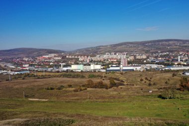 Aerial drone shot of suburban city industrial area buildings clipart