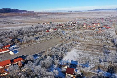 Aerial view of a misty countryside village, in early morning lights by drone clipart