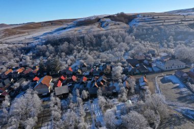 Aerial view of a misty countryside village, in early morning lights by drone clipart