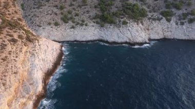 Yunanistan 'ın Thassos adasının kayalık kıyı şeridinde uçan yavaş çekim manzarası