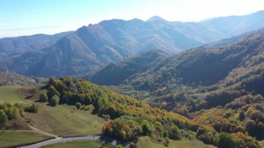 Sisli dağlarla ve insansız hava aracıyla renkli ormanlarla dolu sonbahar havası.
