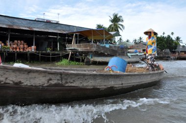 CAI RANG, VİETNAM - 17 Şubat 2013: Mekong deltasındaki ahşap tekneleriyle seyahat eden ve çalışan insanlar sadece tekne ve gemilerde ulaşımın mümkün olduğu yerler