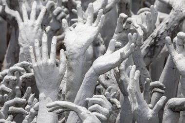 Hands Pleading for Help at Wat Rong Khun at Wat Rong Khun, Chiang Rai, Thailand.
