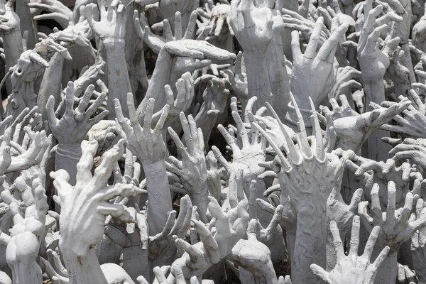 Hands from the Hell at Wat Rong Khun at Wat Rong Khun, Chiang Rai, Thailand.