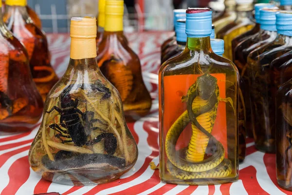 Lao-Lao whisky with snake and scorpion on display at the Don Sao Island market, Golden Triangle, Laos.