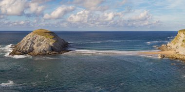 Castro Island and Tombolo of Covachos, Costa Quebrada, Cantabria, Spain. clipart