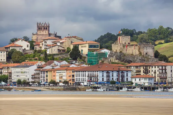 stock image San Vicente de la Barquera, Spain - August 23, 2022: Church of Santa Maria de los Angeles and Castle of the King in San Vicente de la Barquera, Cantabria, Spain.