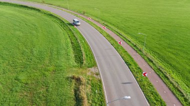 Aerial drone view of asphalt motorway road and bicycle lane from above, transportation infrastructure of the Netherlands clipart