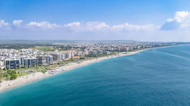 Antalya şehir manzarası ve Konyaalti plajı, kumsalda güneşlenen, denizde yüzen ve dinlenen insanlar, Türkiye 'de Antalya tatil beldesi
