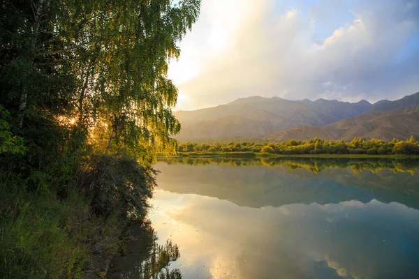 stock image Lake in the mountains. Beautiful nature, reflection of clouds and mountains in blue water. Kyrgyzstan