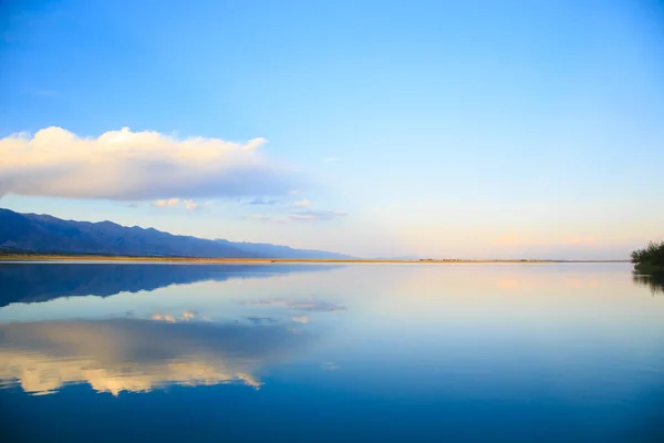 stock image Lake in the mountains. Beautiful nature, reflection of clouds and mountains in blue water. Kyrgyzstan