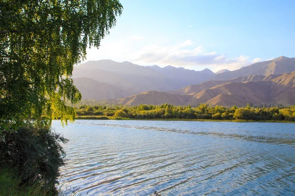 stock image Lake in the mountains. Beautiful nature, reflection of clouds and mountains in blue water. Kyrgyzstan