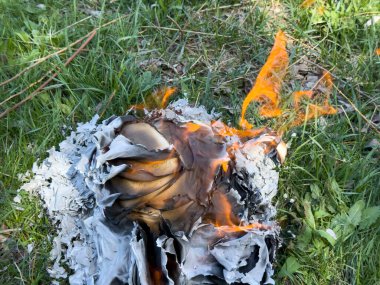 Alevler otları yakarken el yazısıyla yazılmış metinleri içeren defterler.