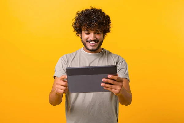Positive Handsome Indian Young Curly Man Using Digital Tablet Web — Fotografia de Stock