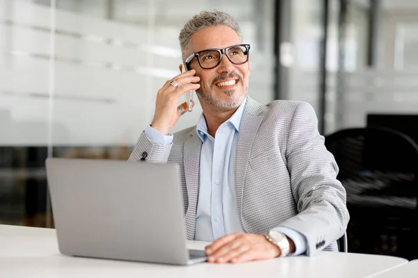 Cheerful Mature 50S Businessman Talking Phone Sitting Laptop His Office — Stock Photo, Image