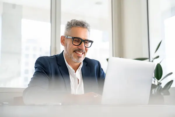 Smiling Mature Businessman Wearing Formal Suit Glasses Using Laptop Office — Stock Photo, Image