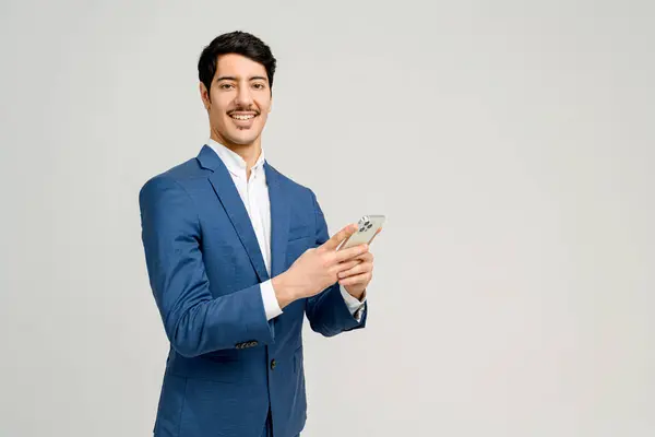 Cheerful Businessman Blue Suit Holds Smartphone His Face Radiating Satisfaction — Stock Photo, Image
