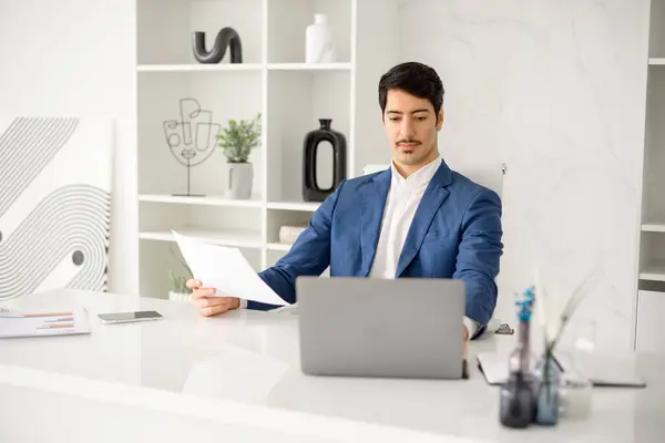 Industrious Hispanic Businessman Engrossed Reviewing Paper Document While Managing Tasks — Stock Photo, Image