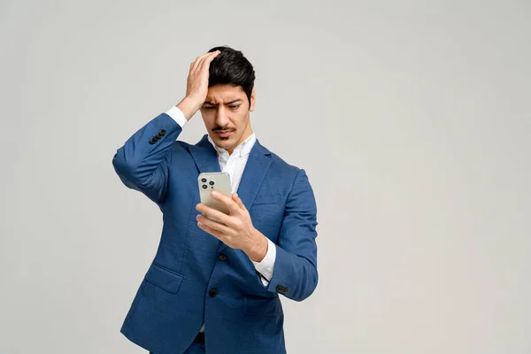 Businessman Blue Suit Expresses Disappointment Confusion While Looking His Smartphone — Stock Photo, Image
