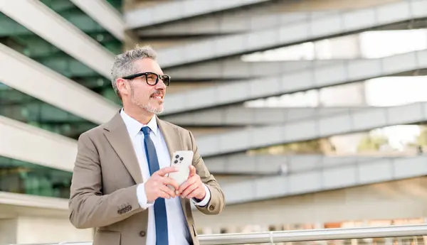 Cheerful Grey Haired Businessman Engaging His Smartphone Outdoors Modern Office — Stock Photo, Image