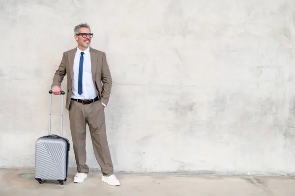 Mature Businessman Smart Suit Stands Suitcase Sporting Cheerful Smile Textured — Stock Photo, Image