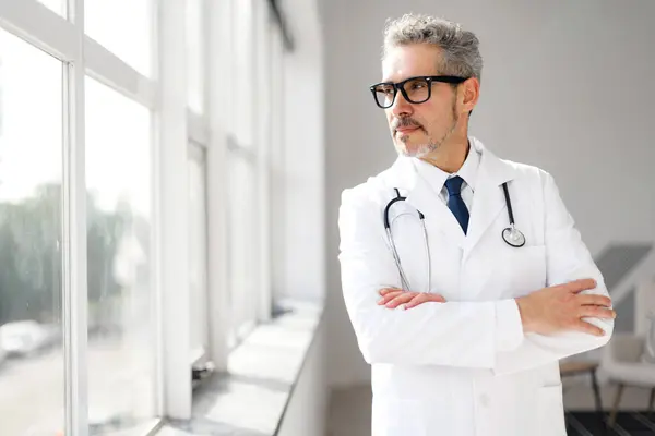 Distinguished Mature Doctor Grey Hair Looks Thoughtfully Out Window His — Stock Photo, Image