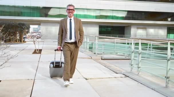 Charismatic Businessman Suitcase Walking Confidently Outdoors His Smile Suggesting Positive — Stock Video