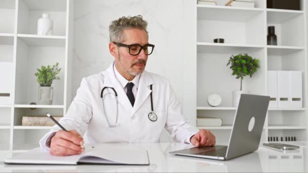 Mature Grey Haired Doctor Engages Patient Video Call His Laptop — Stock Video