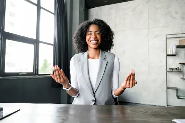 African American Businesswoman Smiles Joyfully She Gestures Video Conference Her Royalty Free Stock Images