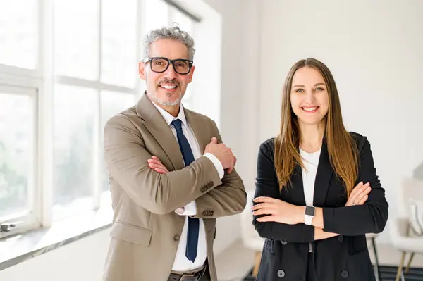 Charismatic Senior Entrepreneur Grey Hair Stands Arms Crossed Next Young Stock Image