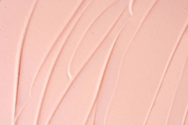 Pink cosmetic clay strokes background. Pink cleanser cosmetic smudge backdrop. Pink clay cosmetic mask textured smears and smudges. Cosmetic clay for face and body skin care procedures.