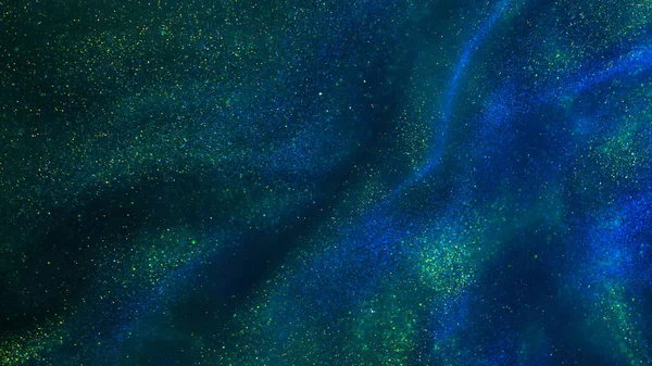 Abstract magic galaxy background. Golden glitter particles on a dark green background with blue hues. Tints of Golden and blue-green dust particles magical stains with depth of field.