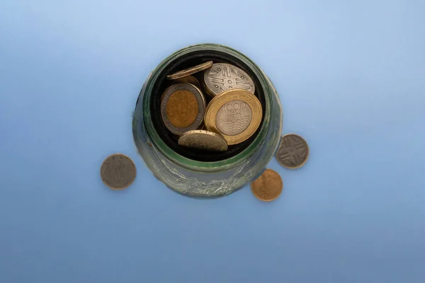 Saving Colombian Coins Glass Cup Stock Image