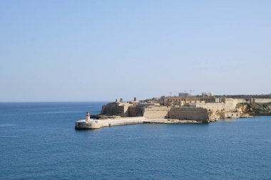 view of the red lighthouse near Fort Ricasoli East Breakwater - Malta
