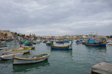 The boats in the harbour look nice, with a typical maltese painting on them