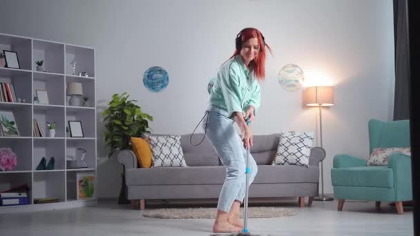 Happy Young Woman Headphones Listening Music Dancing Mop While Cleaning — Αρχείο Βίντεο