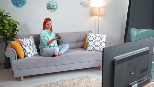 Watching Woman Watching Channels Being Surprised Good News While Sitting — Vídeo de Stock