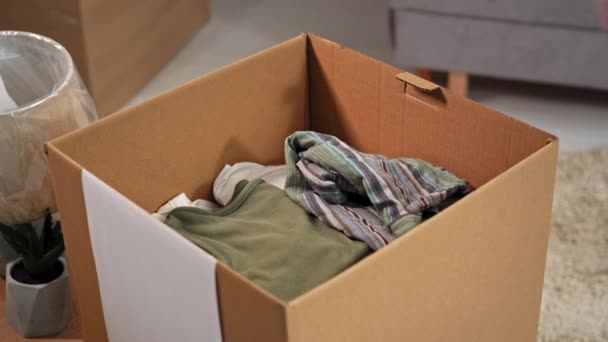 Clothing Packaging Young Female Hands Put Things Clothes Cardboard Box — Stok video