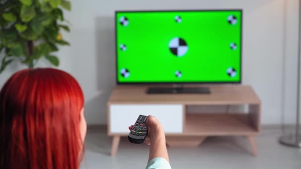 Young Woman Changes Channels Remote Control Space Home Chroma Key — Stock Video