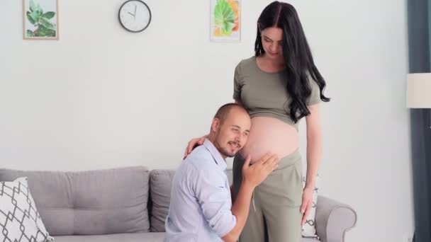 New Life Caring Man Listens Pregnant Wifes Belly Strokes His — Stock videók