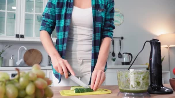 年轻女性在厨房里吃饭的时候 先要节食 然后用搅拌机切新鲜蔬菜 — 图库视频影像