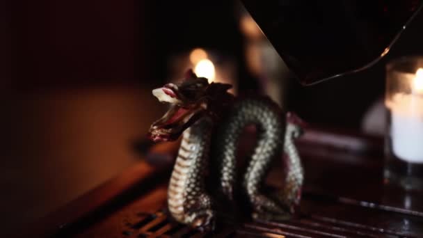 Tea Ceremony Female Master Pours Tea Dragon Figurine Background Candles — Stock Video